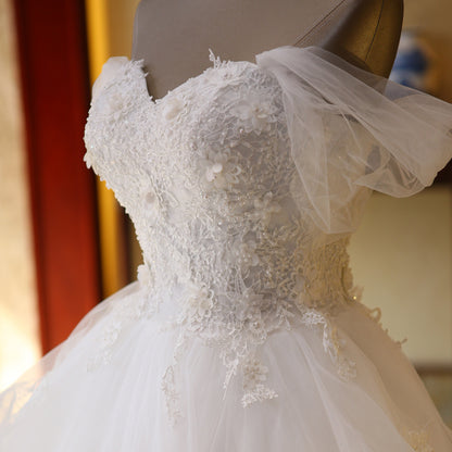 The Bride'S Wedding Dress With Long Tail In Front Of The Studio