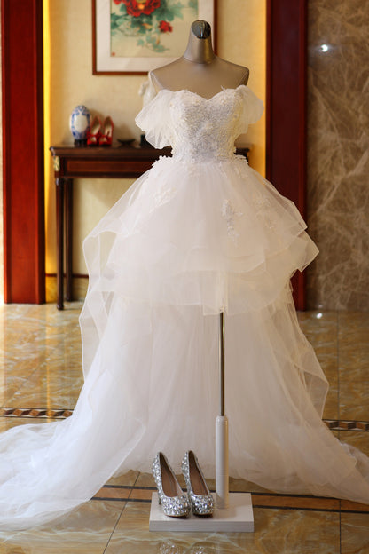 The Bride'S Wedding Dress With Long Tail In Front Of The Studio